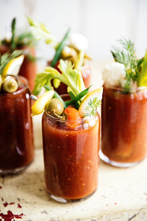 Load image into Gallery viewer, glasses of bloody marys topped with fresh garnishes