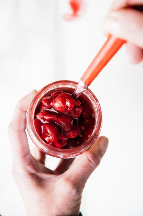Load image into Gallery viewer, Fruit Perfect Sour Cherries being spooned out of the jar