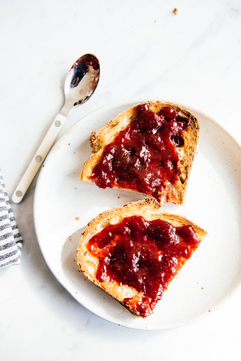 Load image into Gallery viewer, a slice of toast cut in half topped with cherries