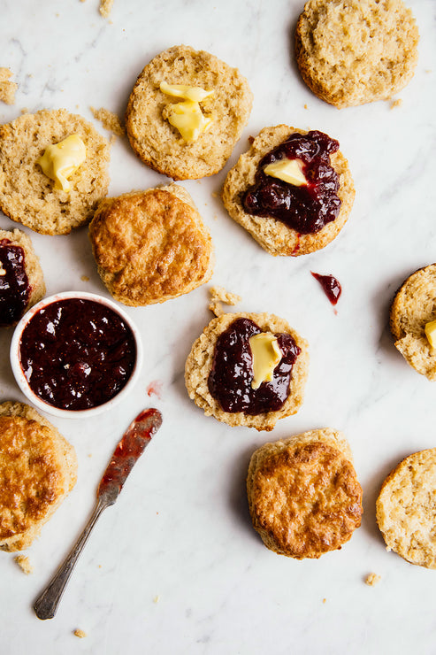 Load image into Gallery viewer, Open face biscuits topped with preserves and butter