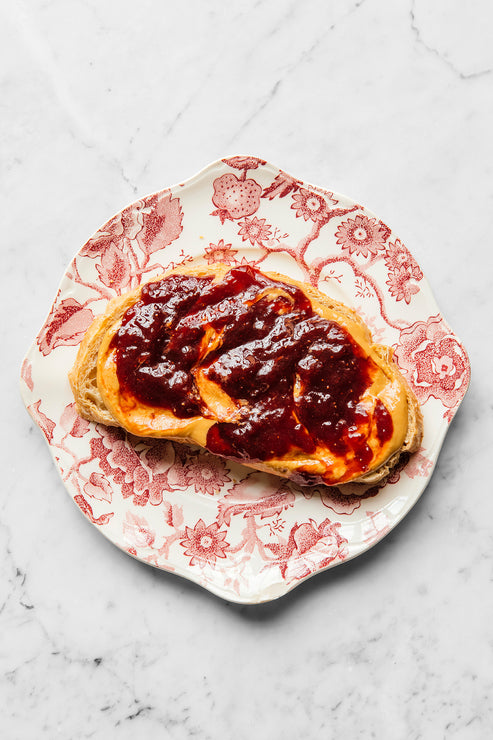 Load image into Gallery viewer, a slice of toast topped with peanut butter and preserves
