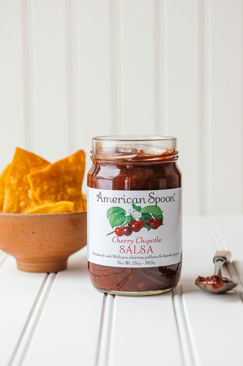 Load image into Gallery viewer, open jar of Cherry Chipotle Salsa with a small bowl of chips