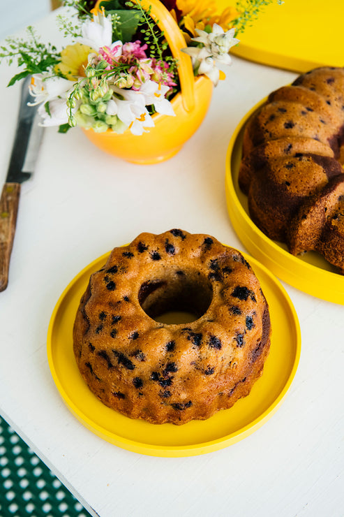 Load image into Gallery viewer, Blueberry Coffee Cakes on yellow plates with flowers and a knife on a white surface