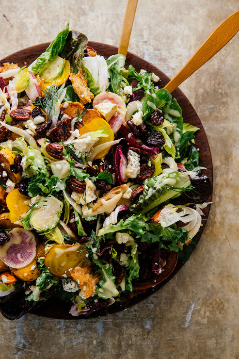Load image into Gallery viewer, a winter salad with shaved brussel sprouts, radishes, blue cheese, lettuce and candied pecans