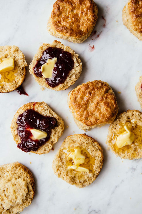 Load image into Gallery viewer, Open face homemade biscuits with preserves and melted butter.
