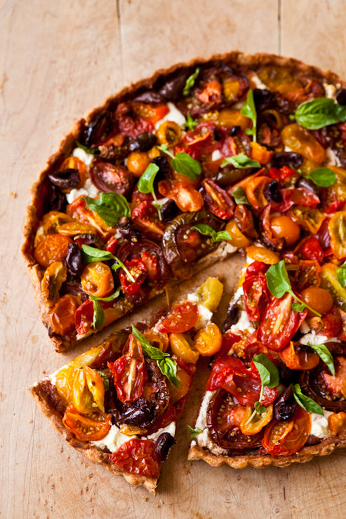 Load image into Gallery viewer, Colorful tomato tart with a slice removed on a wooden surface
