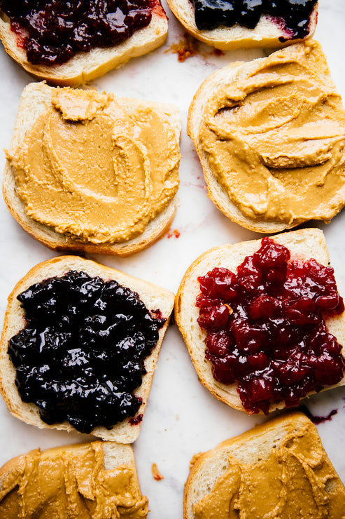 Load image into Gallery viewer, Slices of toast topped with Peanut Butter and preserves