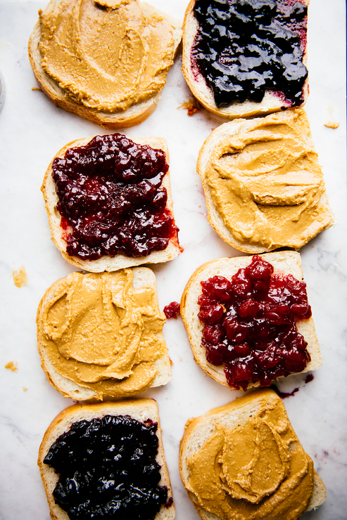 Load image into Gallery viewer, Slices of toast covered in Peanut Butter and preserves