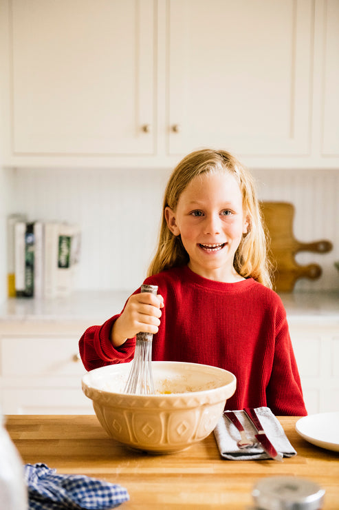 Load image into Gallery viewer, A young girl whisking a bowl of pancake mix