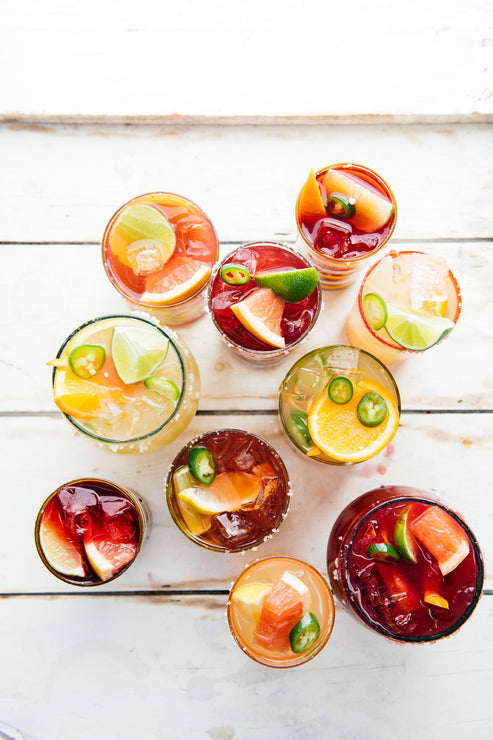 Load image into Gallery viewer, Cocktails made with Paloma Mix, Margarita Mix and Cherry Margarita Mix topped with jalapenos and fresh citrus