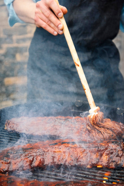 Load image into Gallery viewer, Grilling a rack of ribs made with American Spoon Grilling Sauce