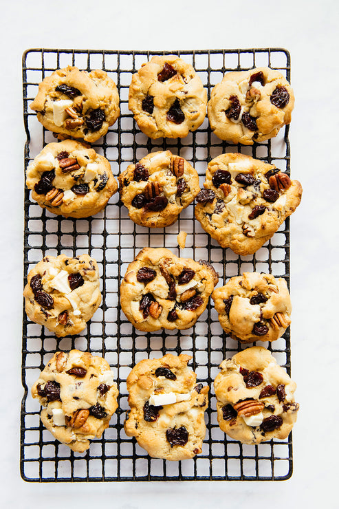 Load image into Gallery viewer, homemade cookies with dried tart cherries, white chocolate and pecans on a cooling rack
