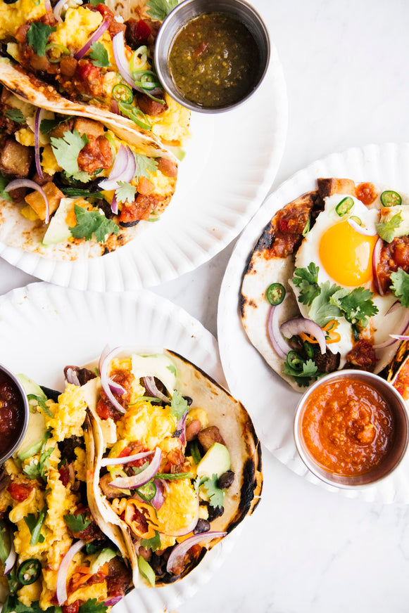breakfast tacos filled with eggs, onions and cilantro topped with american spoon salsa