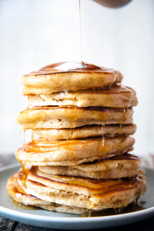 Load image into Gallery viewer, Stack of pancakes with syrup drizzled on top
