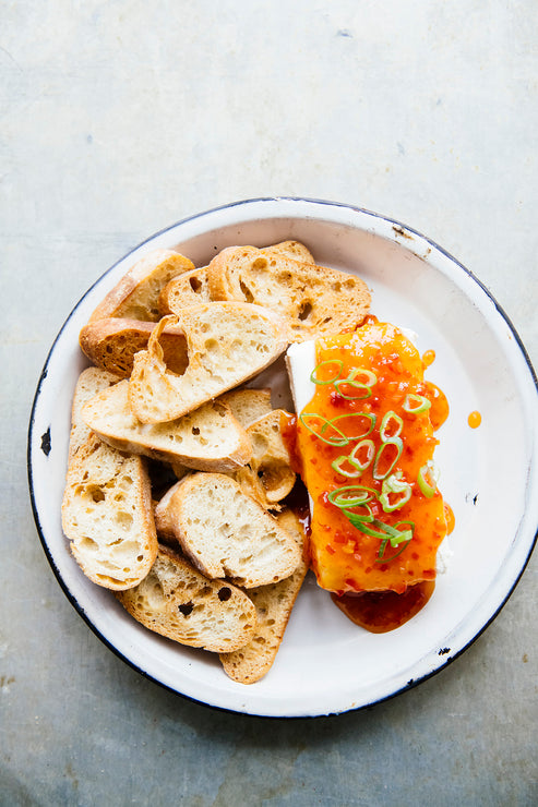 Load image into Gallery viewer, baguette slices next to cream cheese topped with jalapeno pepper jelly
