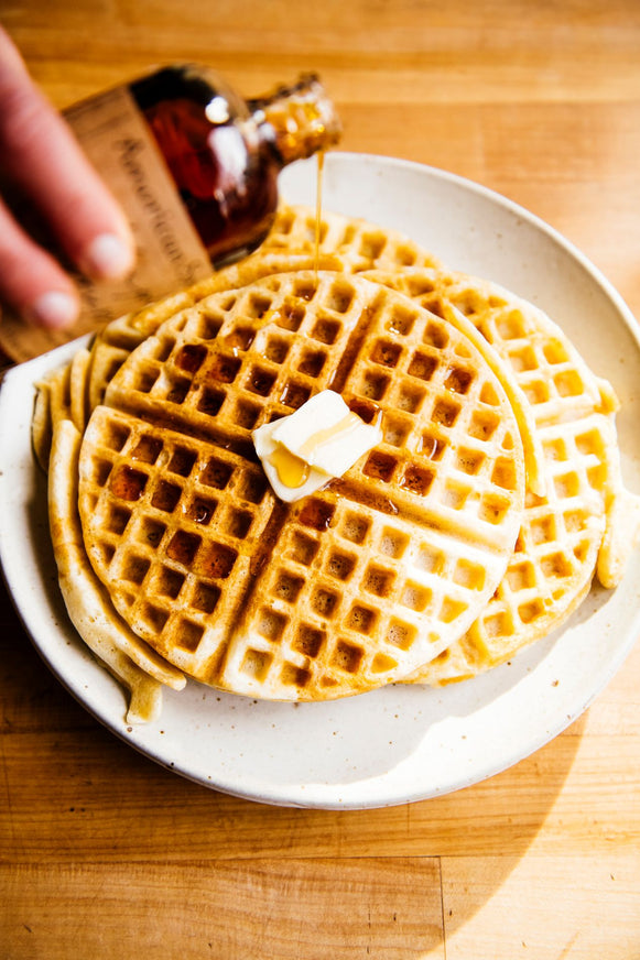 waffles topped with butter and maple syrup