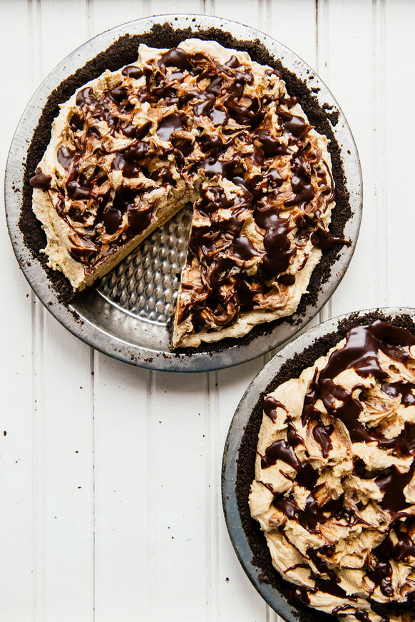 homemade peanut butter and chocolate pies, one with a slice taken out