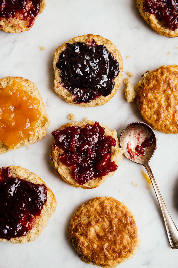 homemade biscuits topped with various preserves and jam