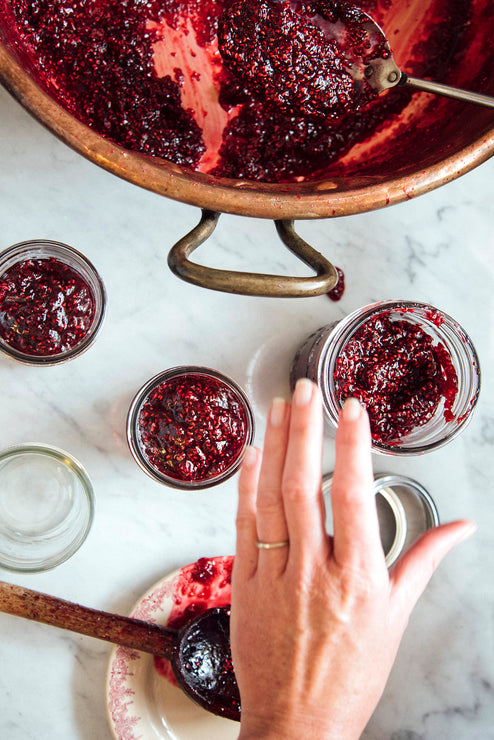 Load image into Gallery viewer, filling jam jars of preserves from a copper kettle
