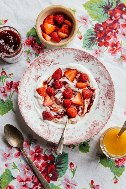 Load image into Gallery viewer, a bowl of yogurt topped with strawberry preserves and fresh strawberries
