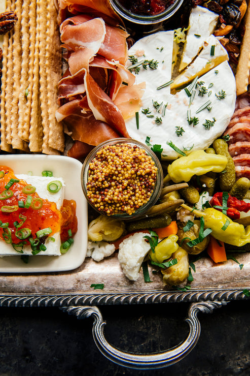 Load image into Gallery viewer, A charcuterie board with various meats, cheese, preserves, mustards and garnishes.
