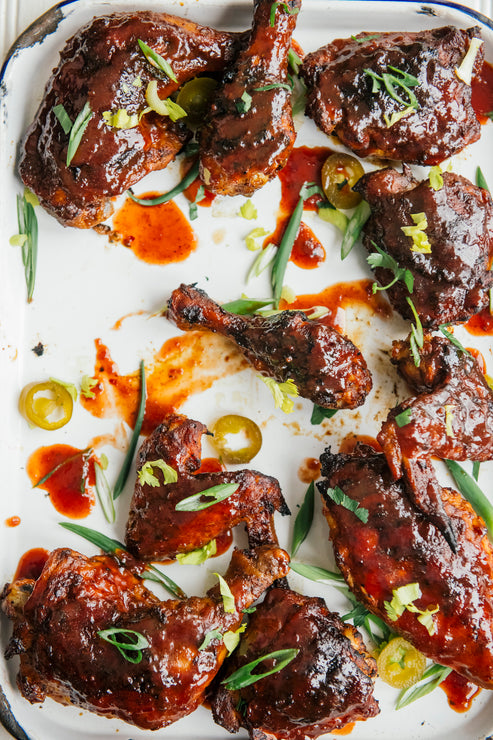 Load image into Gallery viewer, a tray of cherry bbq chicken wings, thighs and drumsticks
