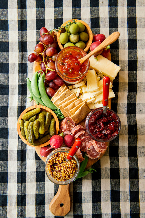 Load image into Gallery viewer, A charcuterie board with various meats, cheese, preserves, mustards and garnishes.
