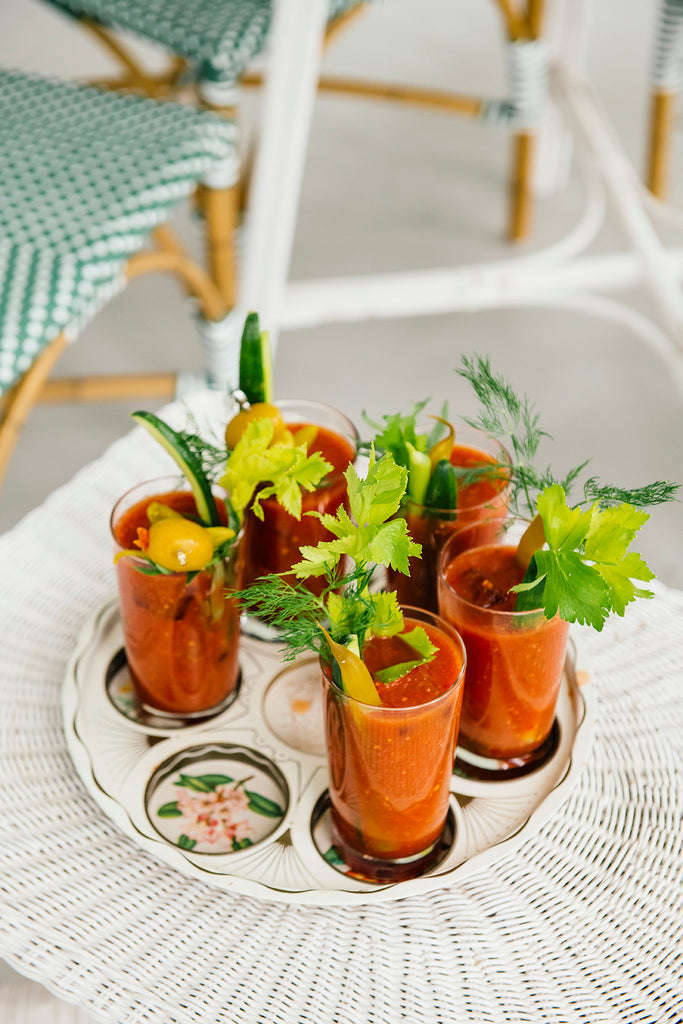 a tray of bloody mary mix topped with fresh garnishes