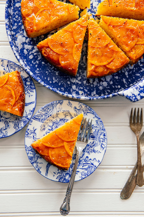 Load image into Gallery viewer, sliced orange marmalade cake on blue floral plates
