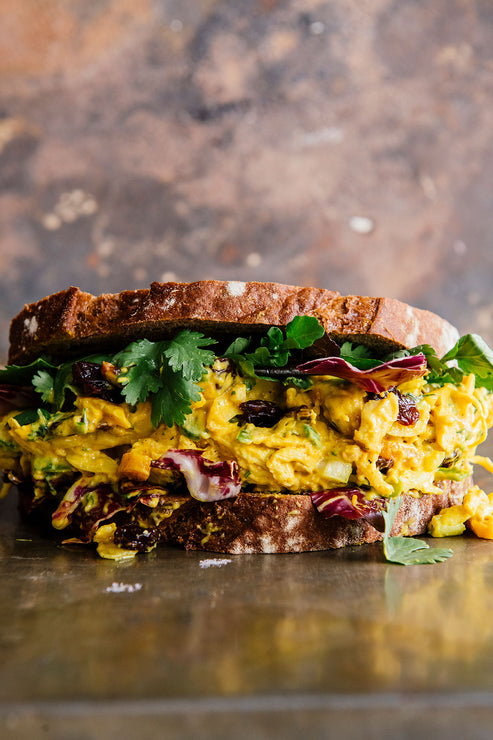 Load image into Gallery viewer, a chicken salad sandwich made with apricot preserves and dried tart cherries
