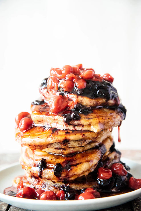 Load image into Gallery viewer, Stack of pancakes topped with Fruit Perfect Sour Cherries, Fruit Perfect Blueberries and Maple Syrup
