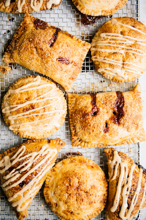 Load image into Gallery viewer, A tray full of hand pies topped with Michigan Maple Cream and filled with preserves
