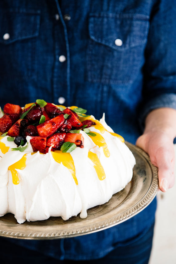 Homemade pavlova topped with Lemon Curd and fresh berries 
