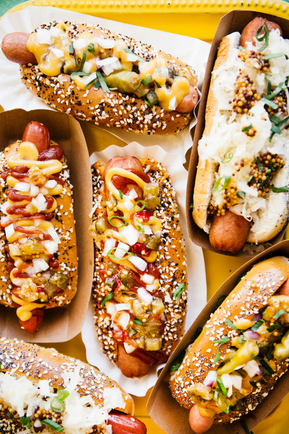 Hot Dogs topped with House Ketchup, Wholeseed Mustard, sauerkraut and onions